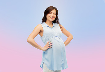 Image showing happy pregnant woman touching her big belly