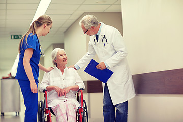 Image showing medics and senior woman in wheelchair at hospital