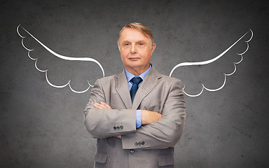 Image showing senior businessman with angel wings over gray