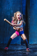 Image showing Halloween theme: Girl with baseball bat ready to hit