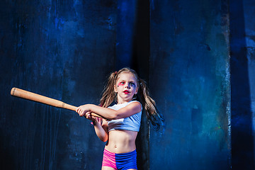 Image showing Halloween theme: Girl with baseball bat ready to hit