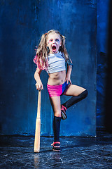 Image showing Halloween theme: Girl with baseball bat ready to hit