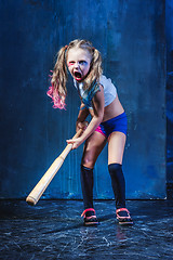 Image showing Halloween theme: Girl with baseball bat ready to hit