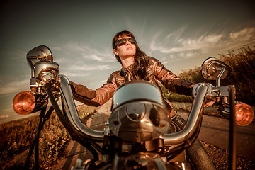 Image showing Biker girl sitting on motorcycle