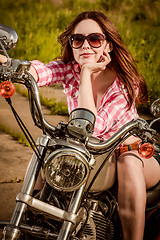 Image showing Biker girl sitting on motorcycle