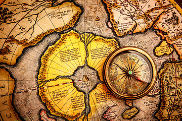 Image showing Vintage compass lies on the ancient map of the North Pole (also 