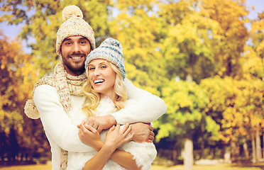 Image showing happy couple in warm clothes over autumn