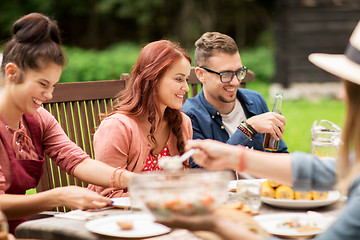 Image showing happy friends having dinner at summer garden party