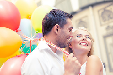 Image showing happy couple with colorful balloons