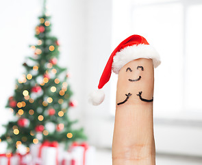 Image showing close up of one finger in santa hat