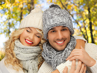 Image showing happy couple in warm clothes over autumn