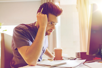 Image showing creative male office worker with coffee thinking