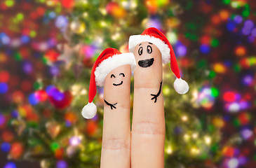 Image showing close up of two fingers with smiley and santa hats