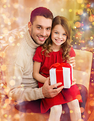 Image showing smiling father and daughter holding gift box