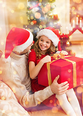 Image showing smiling father and daughter opening gift box