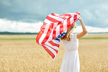 Image showing happy woman with american flag on cereal field