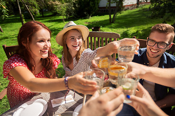 Image showing happy friends having dinner at summer garden party