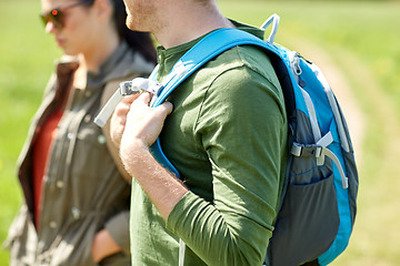 Image showing close up of couple with backpacks hiking outdoors