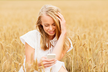 Image showing happy woman with smartphone and earphones