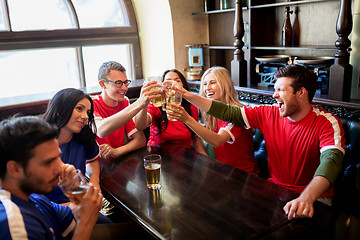 Image showing football fans clinking beer glasses at sport bar