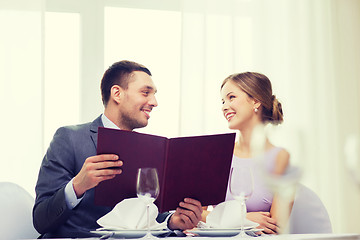 Image showing smiling couple with menu at restaurant