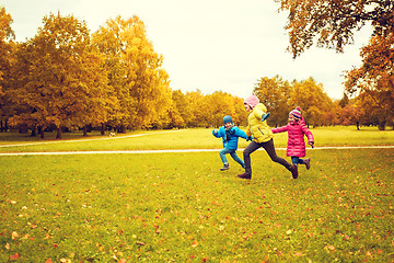 Image showing group of happy little kids running outdoors