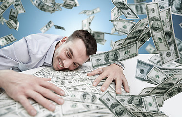 Image showing happy businessman with heap of money