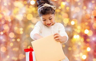 Image showing smiling little girl with gift box