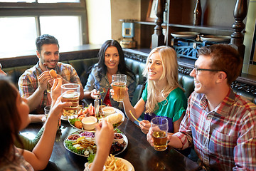 Image showing friends dining and drinking beer at restaurant