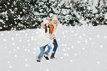 Image showing happy couple running over winter background