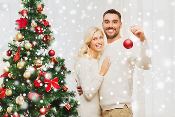 Image showing happy couple decorating christmas tree at home