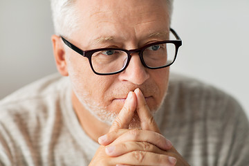 Image showing close up of senior man in glasses thinking