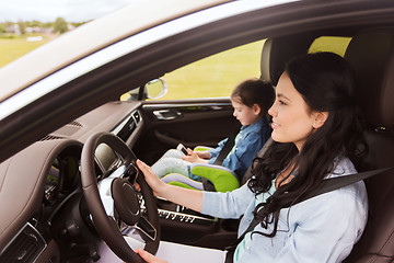 Image showing happy woman with little child driving in car