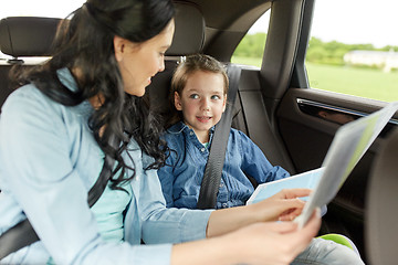 Image showing happy family with travel map driving in car