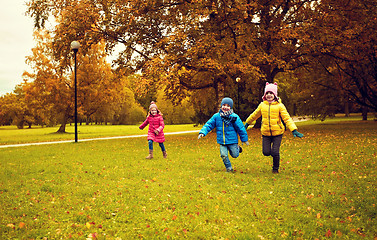 Image showing group of happy little kids running outdoors