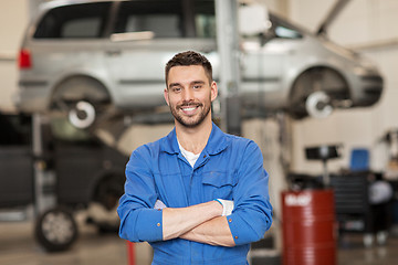 Image showing happy auto mechanic man or smith at car workshop