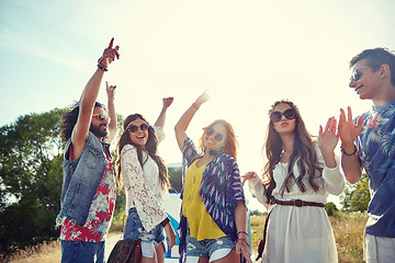 Image showing happy young hippie friends dancing outdoors