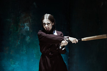 Image showing Portrait of a young girl in school uniform as killer woman