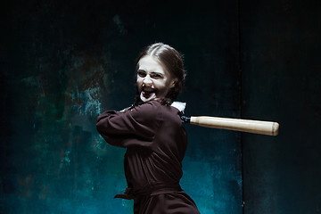 Image showing Portrait of a young girl in school uniform as killer woman