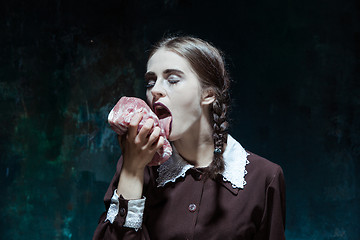 Image showing Bloody Halloween theme: crazy girl with raw meat