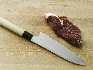 Image showing black angus matured steak with a japanese knife