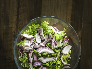 Image showing bowl of real salad in on a wooden table