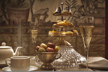 Image showing luxury afternoon hot tea with champagne and macaroons