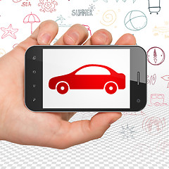 Image showing Vacation concept: Hand Holding Smartphone with Car on display