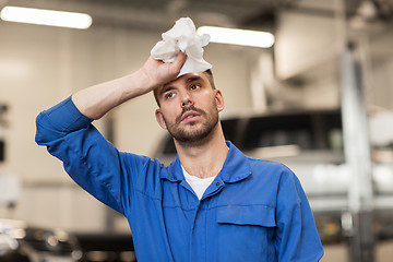 Image showing tired auto mechanic man or smith at car workshop