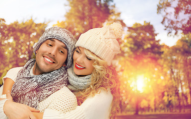 Image showing happy couple in warm clothes over autumn