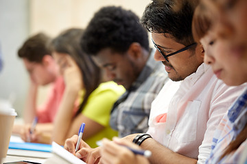 Image showing group of international students writing at lecture