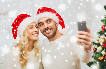 Image showing couple taking selfie with smartphone at christmas