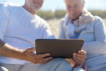 Image showing close up of senior couple with tablet pc on beach