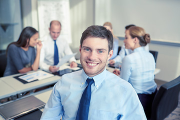 Image showing group of smiling businesspeople meeting in office